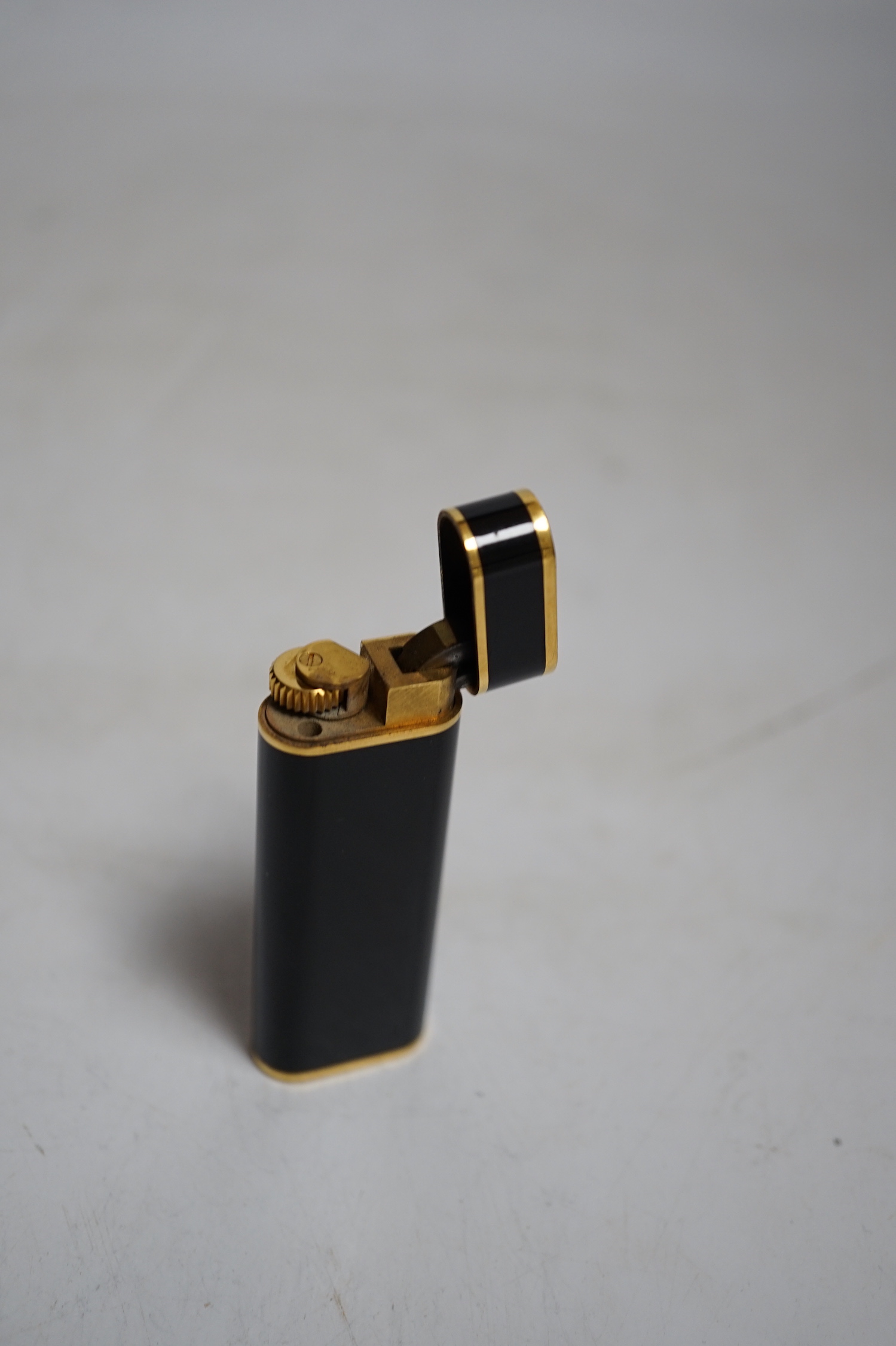 Cartier, black enamel and gold plated lighter